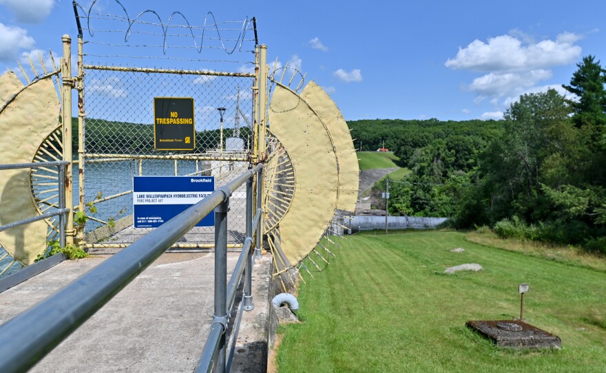 The stop of the dam at Lake Wallenpaupack is gated off. To the left, a pipe carries water to a facility to make electricity.