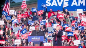 Donald Trump welcomes Mark Robinson on stage Saturday to a crowd of hundreds at The Farm at 95 in Selma, North Carolina.