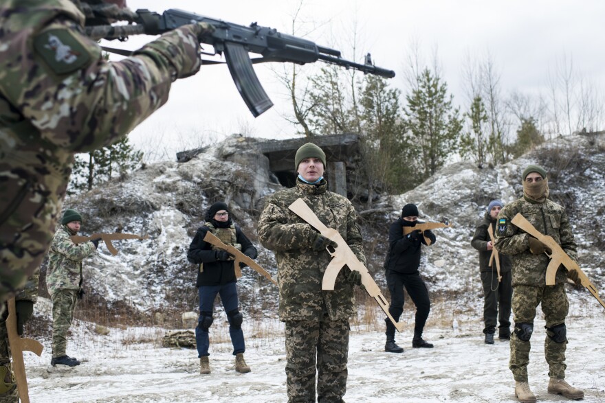 Members of Ukraine's Territorial Defense Forces take part in a Saturday morning training outside Kyiv. New members who have not yet trained with the unit must begin with the basics, and wooden mock weapons, regardless of their experience level.