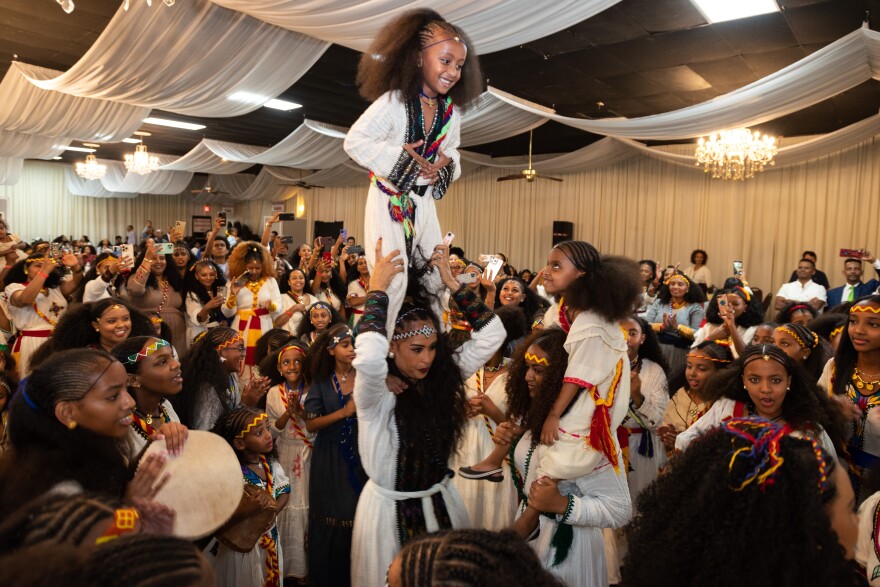 Atsede Abade carries Absilat Amanuel on her shoulders as the two lead a group of female dancers at the start of this year's Tigrayan festival of Ashenda, on Saturday, Sept. 02, 2023 at the Garland Convention & Reception Center. Ashenda is a Tigrinya word meaning tall green grass. The festival celebrates females especially teen and younger girls. The day is considered a freedom day for girls to sing and dance in the streets with their friends and family.