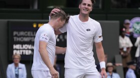 Harri Heliovaara, left, of Finland and Henry Patten of Britain celebrate after defeating Australia's Max Purcell and compatriot Jordan Thompson in the men's doubles final at the Wimbledon tennis championships in London, Saturday, July 13, 2024.(AP Photo/Alberto Pezzali)