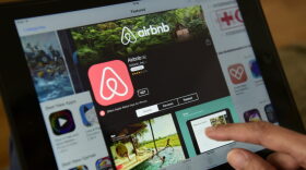 A woman browses the site of US home sharing giant Airbnb on a tablet.