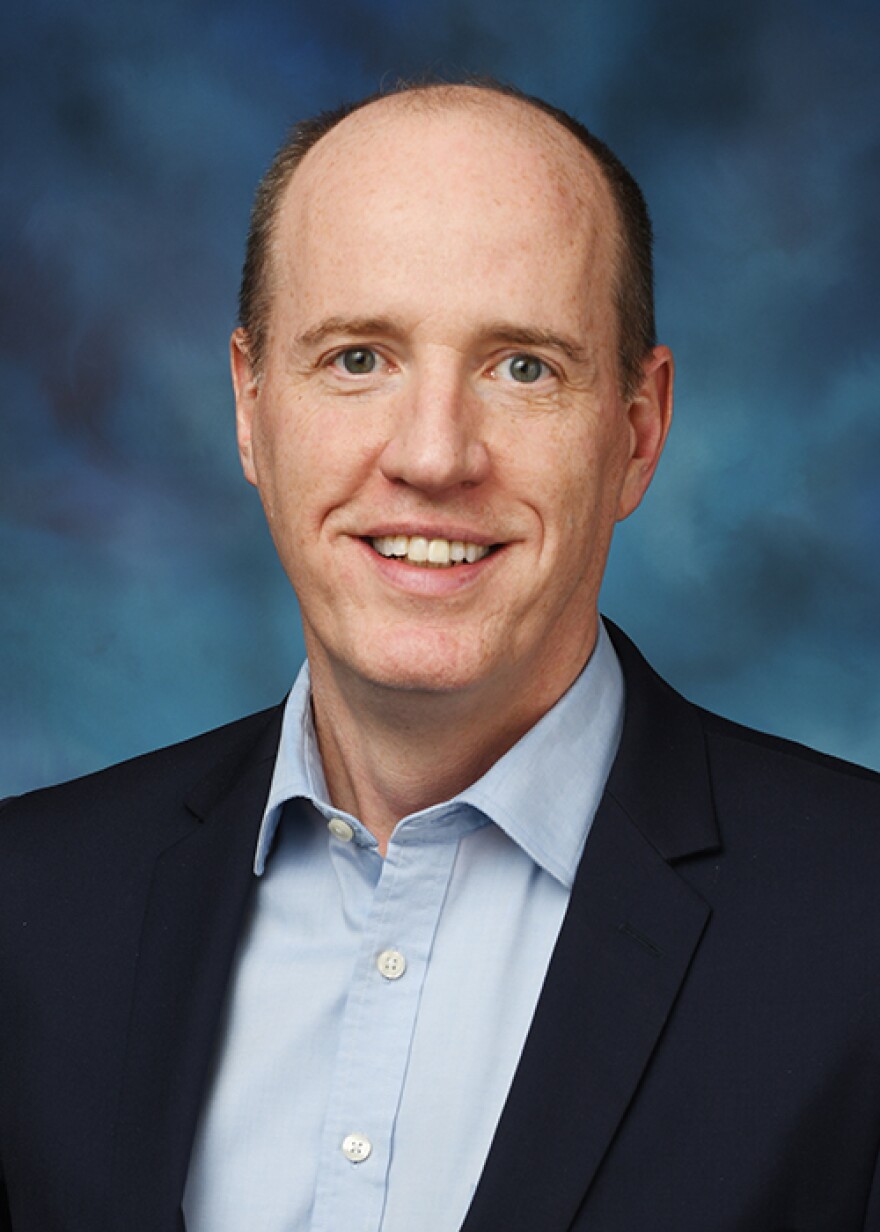 Senator Cunningham with black blazer and blue collared shirt