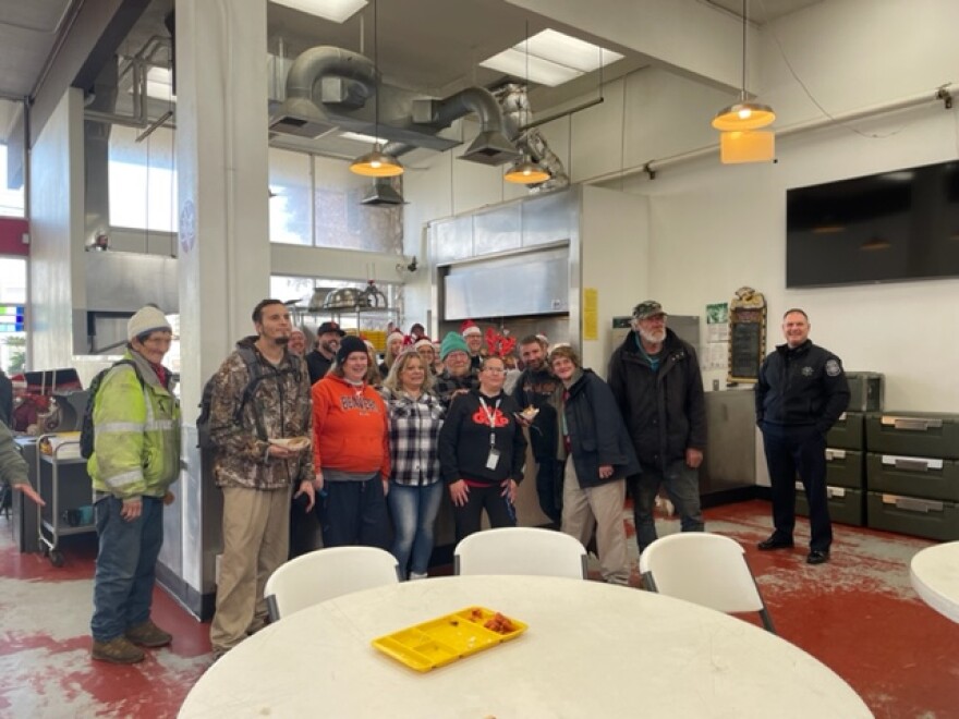 EPD staff served over 150 holiday meals to needy and unhoused people coming into the Lindholm Center Tuesday. Eugene Police Chief Skinner (far right) said he's proud of this kind of "community policing" being shown.