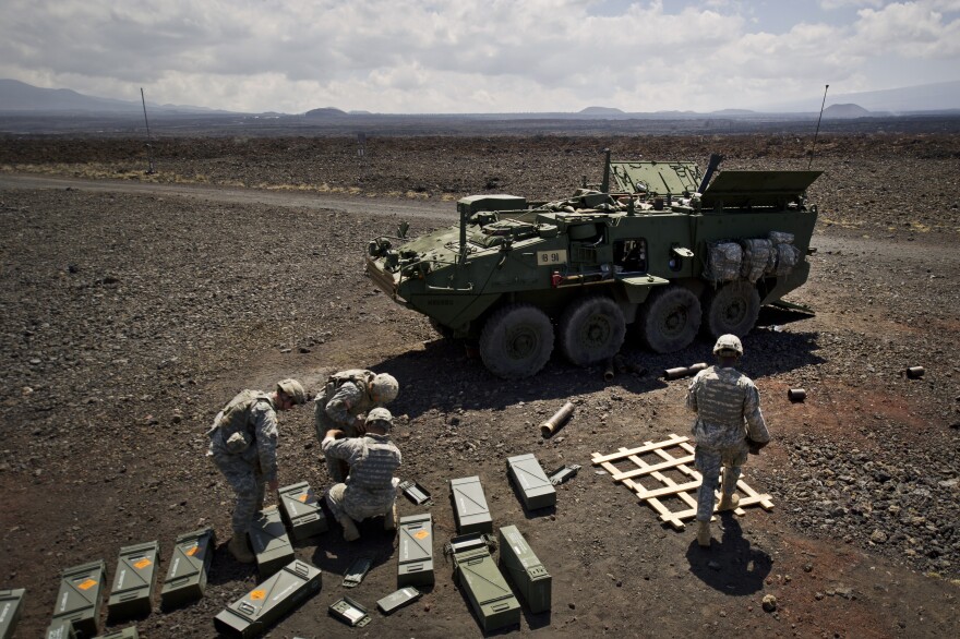 U.S. Army soldiers from Bravo Company 1st Battalion, 21st Infantry Regiment, "Gimlets" 2nd Stryker Brigade Combat Team, 25th Infantry Division, prepare and resupply 120 mm mortar rounds prior to a fire mission from a Mounted Mortar Carrier (MC-B) 37 Sept. 20, 2012, at the Pohakuloa Training Area, on Hawaii's Big Island. (Department of Defense photo by U.S. Air Force Tech. Sgt. Michael R. Holzworth/Released)