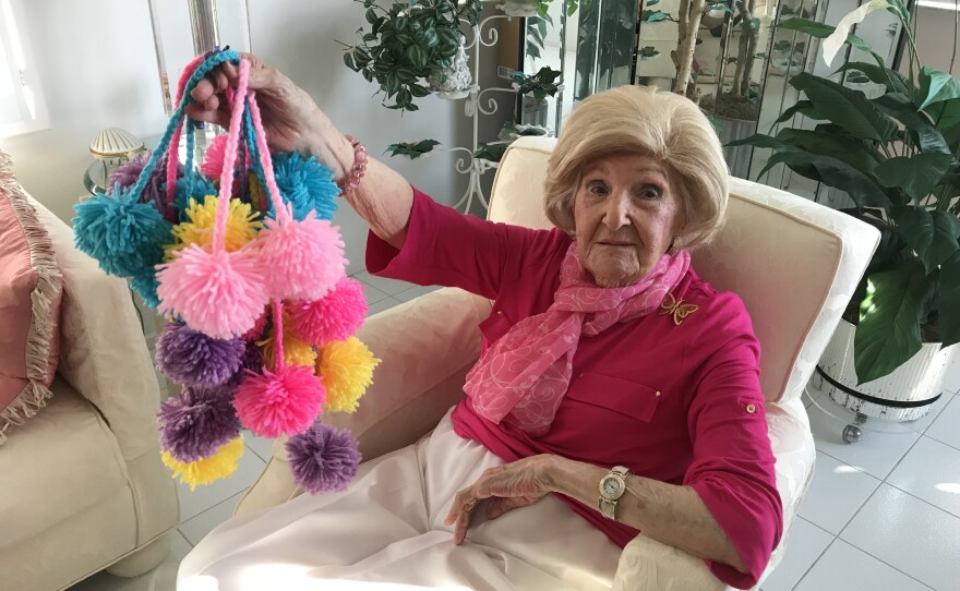 woman holding pom poms