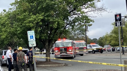 William "Trey" Mayo (far left), the Fire Chief for the City of Winston-Salem, consults with fire fighters on the scene at last week's food truck fire in front of LJVM Coliseum.