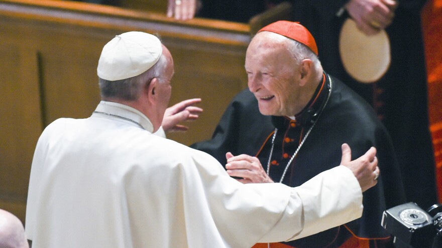 Pope Francis embraces then-Cardinal Theodore McCarrick during a 2015 visit to the U.S. McCarrick resigned the cardinalate last year before being defrocked Saturday.