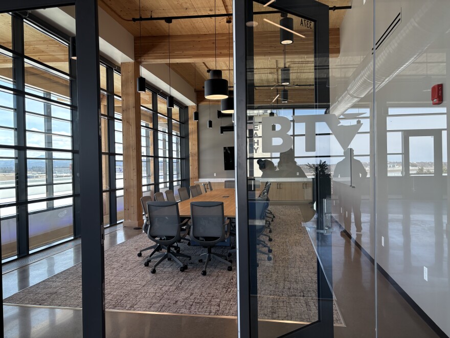 A conference room with glass walls and a mountain view