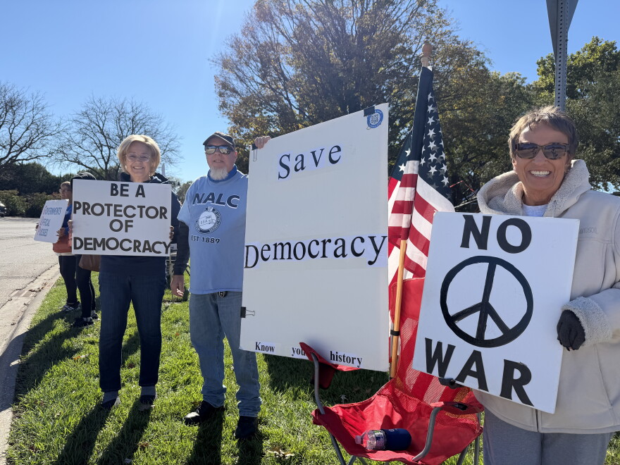 Lynn Solontoi and Eric Oberg of Monmouth and Vanessa Bell of Galesburg at the No Kings: Vote Early rally in Galesburg.