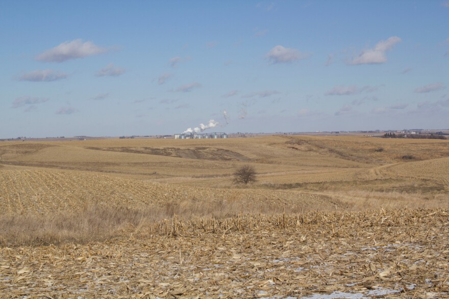 A crop field at Whiterock Conservancy, which experiments with land conservation techniques, near Coon Rapids, Iowa, with an ethanol plant on the horizon.