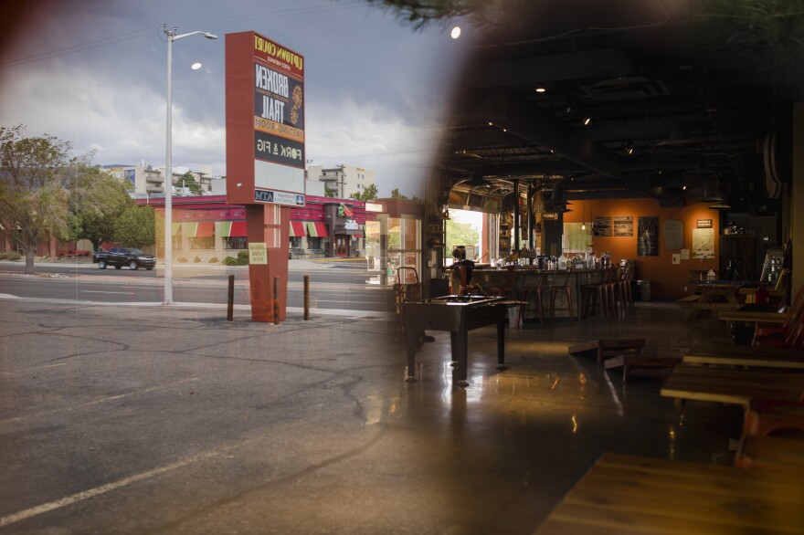 A window reflection through the empty inside of Broken Trail Distillery & Brewery in Albuquerque, N.M. Matt Simonds is the owner and has struggling to keep his business afloat since pandemic lockdown orders were issued in March.