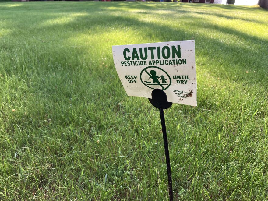 A sign warns of a recent pesticide application on a lawn in northern Michigan. Entomologist Zach Schumm thinks the term "pest" in unfair to the thousands of diverse species of insects that serve foundational ecological roles. He recommends people only use pesticides as a last resort, if at all.