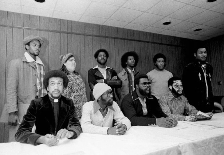 A January 1976 file photo of the Wilmington Ten at a news conference in Raleigh. Front: Benjamin Chavis, William Wright, Connie Tindall, and Jerry Jacobs. Back: Wayne Moore, Ann Shepard, James McKoy, Willie Vereen, Marvin Patrick, and Reginald Epps.