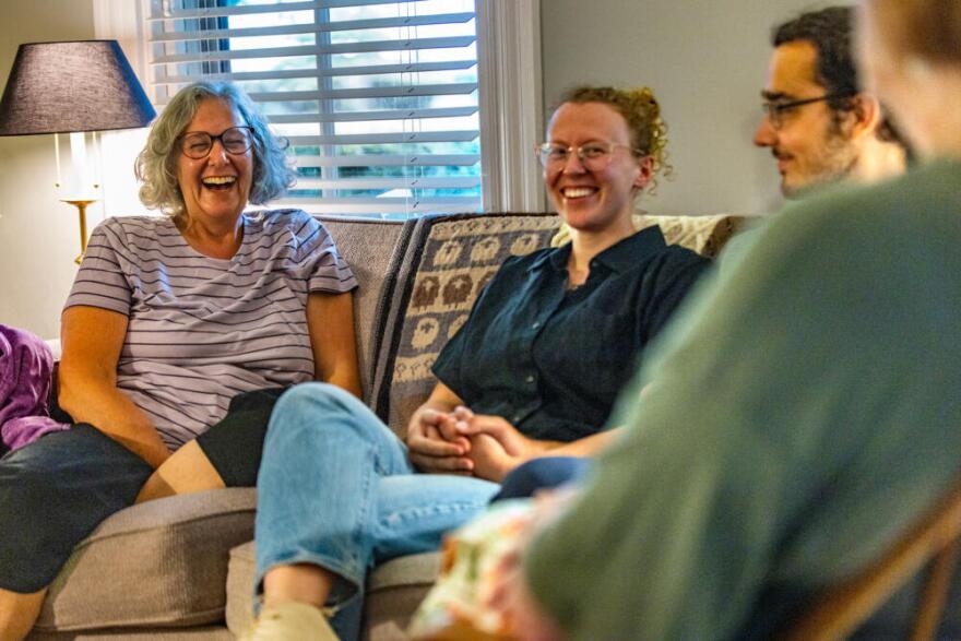 Pam McColl, left, and Jacqui Comstock laugh during a conversation with Jacqui’s mother, Ruth Comstock, about their meeting for the first time. (Jesse Costa/WBUR)
