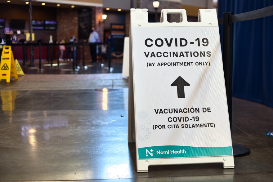 A photo that indicates where the lines for COVID-19 vaccinations begins.