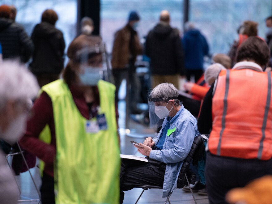 Workers and patients at a pop-up COVID-19 vaccination site near downtown Seattle in January. "The vast majority who are coming in do appear to be meeting the eligibility criteria," says Dr. Jeff Duchin, King County's public health officer.