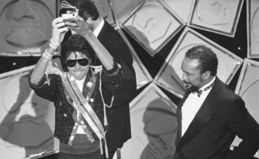 Michael Jackson, left, holds up his Grammy for Best Album of the Year as Quincy Jones looks on, in 1984. Rod Temperton wrote three of the hit songs for Jackson's smash album <em>Thriller</em>.