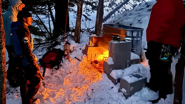 A good old-fashioned fire melts snow which then runs down the face of a rock wall at Kona Hills Campground in Marquette. The effort is meant to provide a consistent surface for climbers who come to the U.P. looking for ice, which has been less predictable in recent winters. (Photo courtesy of Kona Hills)