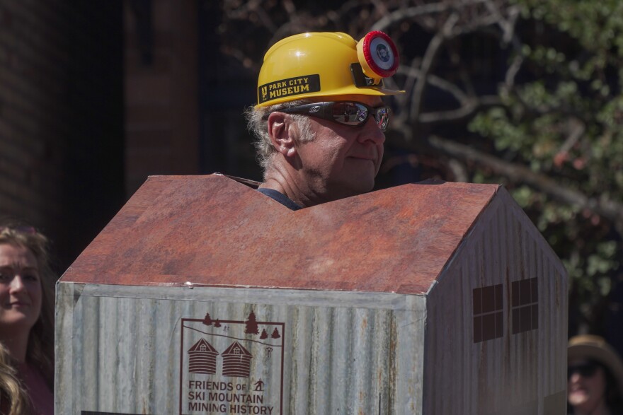 Friends of Ski Mountain Mining History member sports a cardboard version of the historic Silver King Coalition Mine main building during the 2025 Miners Day parade.