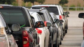 Cars lined up ahead of Friday's Mass Distribution at the Alamodome