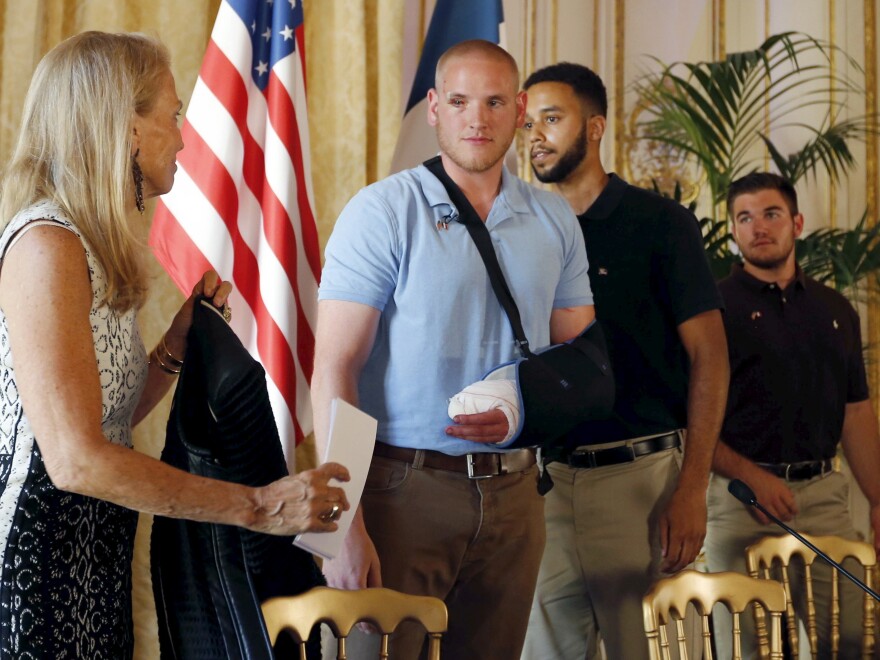 U.S. ambassador to France Jane Hartley presents U.S Airman 1st Class Spencer Stone, student Anthony Sadler and National Guardsman Alek Skarlatos at a news conference at the U.S. Embassy in Paris on Sunday.