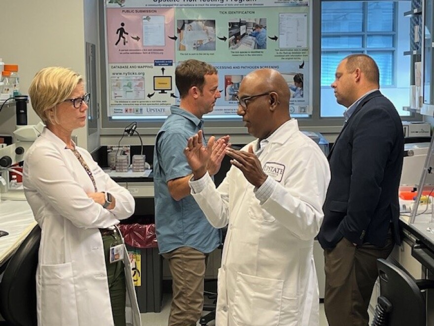 Onondaga County Health Commissioner Dr. Katie Anderson, left, and Dr. Saravanan Thangamani, front, have a chat.