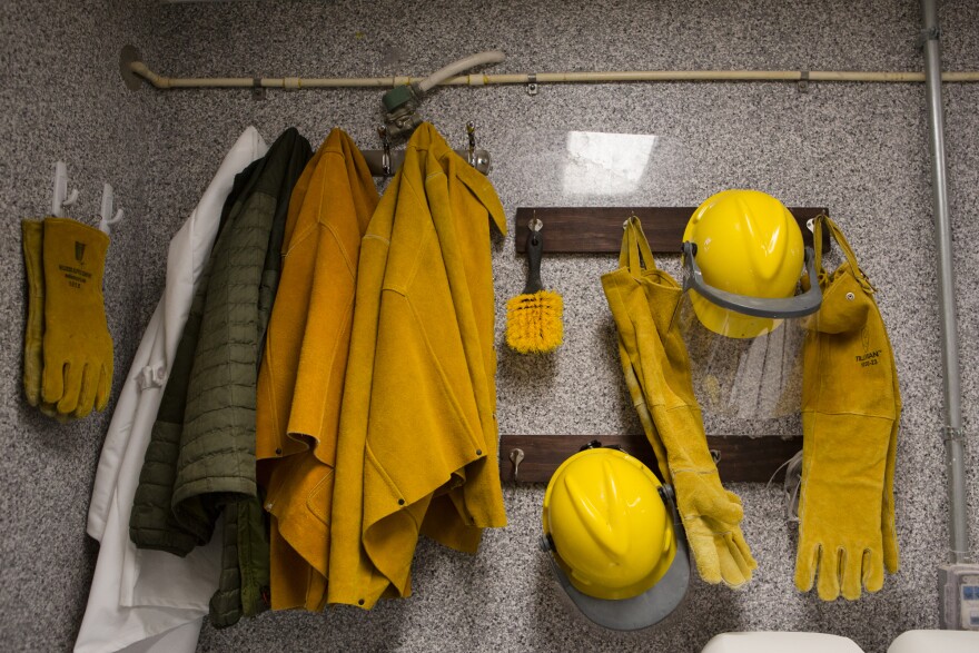 Leather jackets, helmets and gloves that scientists wear to protect themselves hang in the owl room at Johns Hopkins.