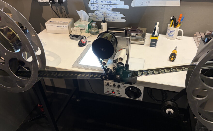 This reel to reel cleaning set up takes film reels and moves them through media cleaning cloths to remove dust and smudges without scratching the celluloid.