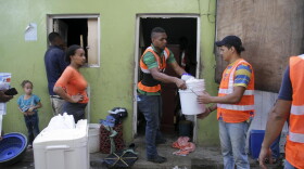 Maria Isabel Reyes watched workers pack up her life. "I feel nervous," she said. (Mariana Dale/KJZZ)