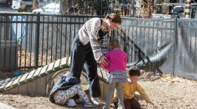 Hallie Lawyer, a teacher with Ajax Cubs, runs around with preschool kids on the Yellow Brick Building Playground on Friday.