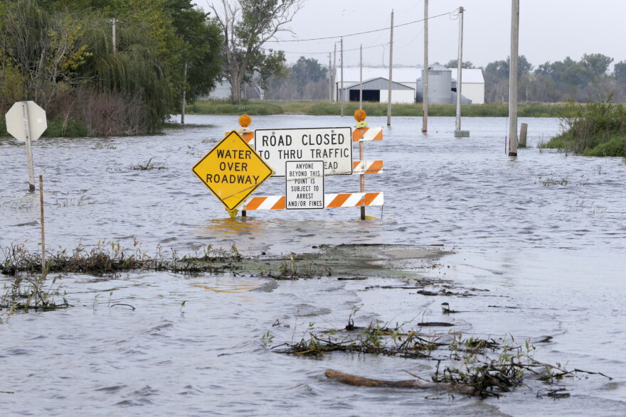 Rising flood waters from the Missouri River cover a road in Honey Creek, Iowa, Wednesday, Sept. 18, 2019. The Iowa Department of Transportation warned drivers that if the river continues to rise they might have to close a portion of Interstate 29 north of Council Bluffs, Iowa. (AP Photo/Nati Harnik)