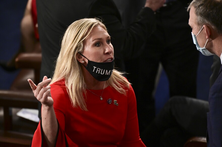 Rep. Marjorie Taylor Greene, R-Ga., seen here on the opening session of Congress on Jan. 3 with her "Trump Won" face mask pulled down, has been outspoken on her controversial views for a while.