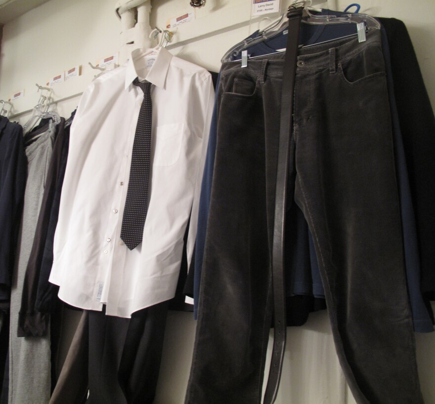 The costumes hanging in David's dressing room aren't too far from his schlumpy wardrobe from <em>Curb Your Enthusiasm. </em>"Why can't I just wear my own clothes?" David asks.