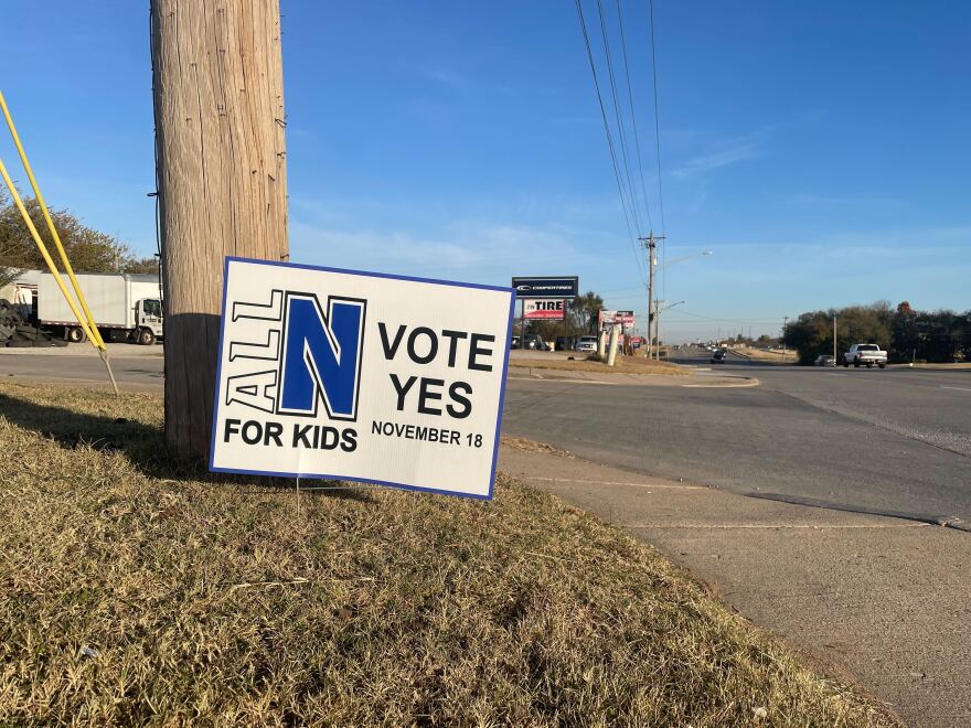 A yard sign encourages voters to support Newcastle's school bond.