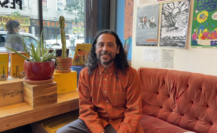 Josiah Luis Alderete sits on a couch at the newly opened Medicine for Nightmares bookstore and gallery.