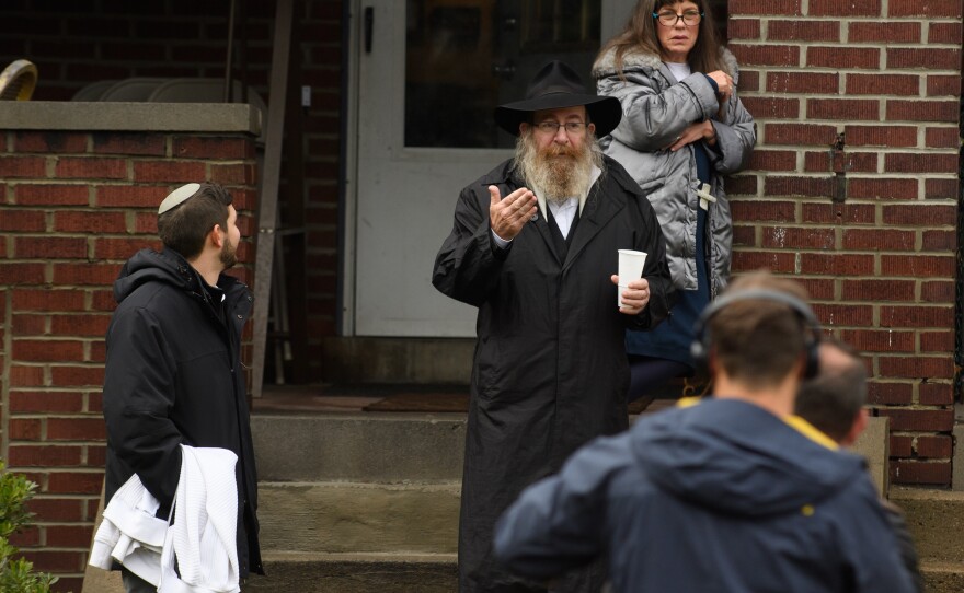 Residents talk to the media near the site of a mass shooting at the Tree of Life Synagogue.