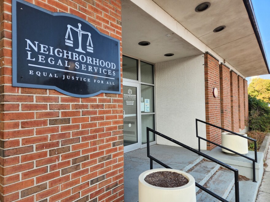 The stairs to a brick building with the sign "Neighborhood Legal Services. Equal Justice For All."