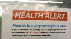 A notice for a health alert about measles is posted on the door of a medical facility Wednesday, Feb. 13, 2019, in Seattle. A recent measles outbreak has sickened more than 50 people in the Pacific Northwest, most in Washington state and, of those, most are concentrated in Clark County, just north of Portland, Oregon. Washington Gov. Jay Inslee declared a state of emergency over the outbreak last month. (AP Photo/Elaine Thompson)