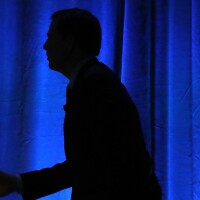 FBI Director James Comey walks up to speak on cybersecurity in August. His decision to release a letter noting he's looking into more Clinton emails has rocked the presidential election.