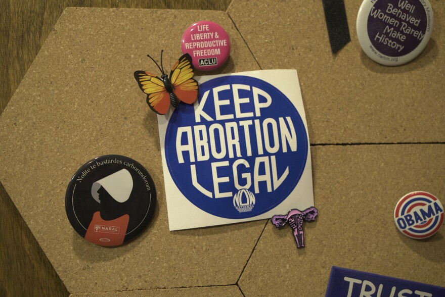 A button evoking "The Handmaid's Tale," a novel about repression of women in a United States that has become a Christian theocracy, hangs on a cork board at the West Alabama Women's Center in Tuscaloosa, Ala., on Tuesday, March 15, 2022. (AP Photo/Allen G. Breed)