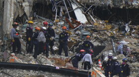 Search and rescue personnel work atop the rubble at the Champlain Towers South condo building, where scores of people remain missing almost a week after it partially collapsed, Wednesday, June 30, 2021, in Surfside, Fla. (AP Photo/Lynne Sladky)