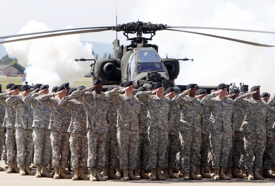 FILE - In this Friday, May 13, 2011 file photo, Soldiers of 1AD attend a color casing ceremony of the First Armored Division at the US Army Airfield in Wiesbaden, Germany. After more than a year of thinly veiled threats that the United States could start pulling troops out of Germany unless the country increases its defense spending to NATO standards, President Donald Trump appears to be going ahead with the hardball approach with a plan to reduce the American military presence in the country by more than 25 percent. (AP Photo/Michael Probst, file)