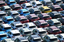 Rows of new cars packed tightly together with no space to move any of them.