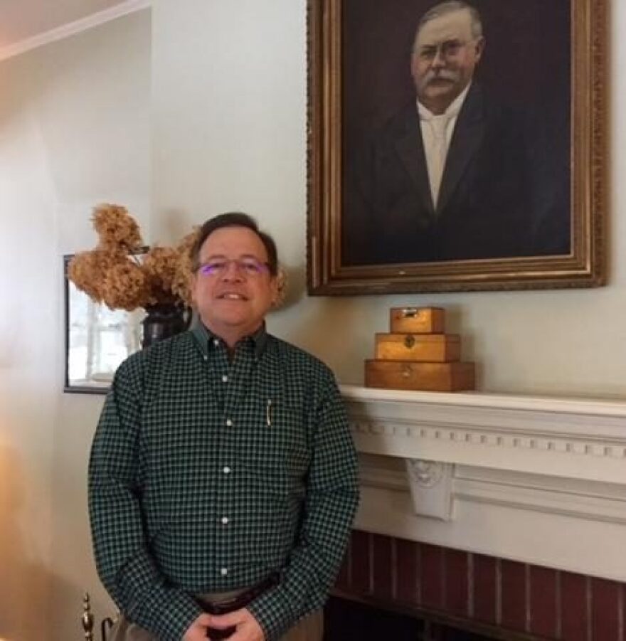 Richard Tollner, who is childhood sexual abuse survivor, stands in front of a portrait of his grandfather at his home in rural Albany County. CREDIT KAREN DEWITT / WSKG NEWS