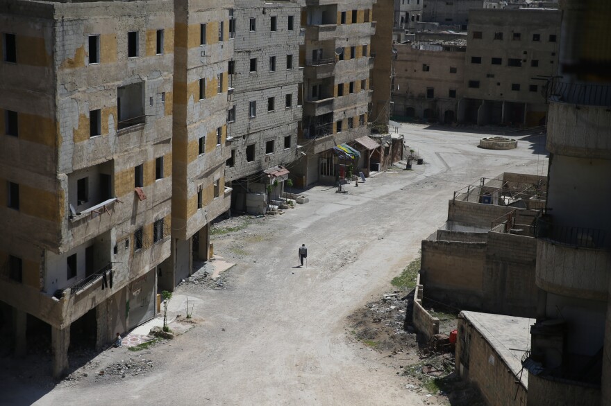 April 7, 2017: Ain Tarma — Abu Malek, one of the survivors of a chemical attack that took place in this location in 2013, uses his crutches to walk along a deserted street.