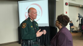 Pinellas County Sheriff Bob Gualtieri (left), the chair of the Public Safety Commission, speaks with Broward County administrator Bertha Henry on Thursday.   