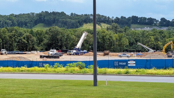 Construction equipment are spaced out across a dirt field where a proposed hyperscale data center is being built.