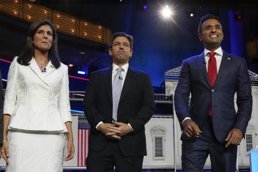 Republican presidential candidates former U.N. Ambassador Nikki Haley, Florida Gov. Ron DeSantis and businessman Vivek Ramaswamy pose for a photo before the start of a Republican presidential primary debate hosted by NBC News, Wednesday, Nov. 8, 2023, at the Adrienne Arsht Center for the Performing Arts of Miami-Dade County in Miami. (AP Photo/Wilfredo Lee)