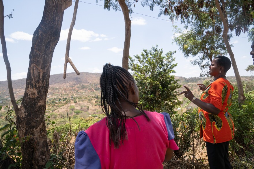 Joyce Mutisya (left) talks with community health volunteer Susan Mutua, who screened her for possible dementia several months ago. Mutisya's responses raised enough red flags for Mutua to refer her to the local hospital for a professional opinion.